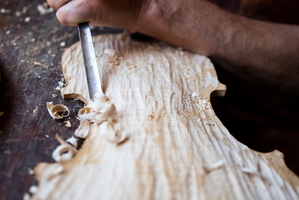 A person using a chisel to cut wood