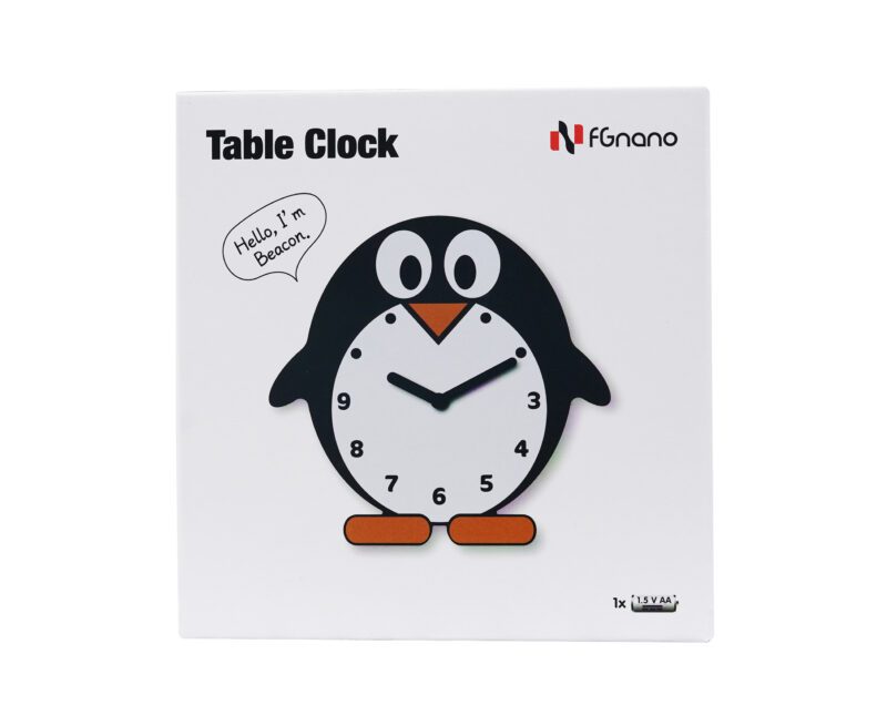 A penguin clock sitting on top of a table.