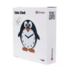 A box with a penguin clock sitting on top of it.
