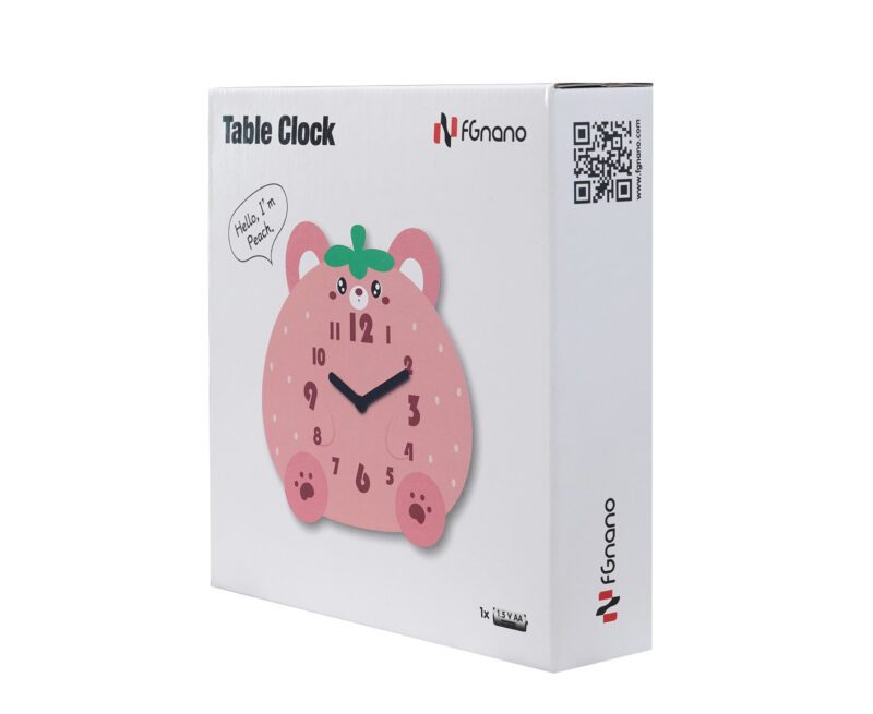 A pink table clock sitting on top of a box.